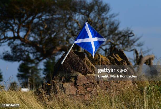 Saltire pin flag rest against a stone wall at the 14th hole ahead of the Aberdeen Standard Investments Ladies Scottish Open Previews at The...