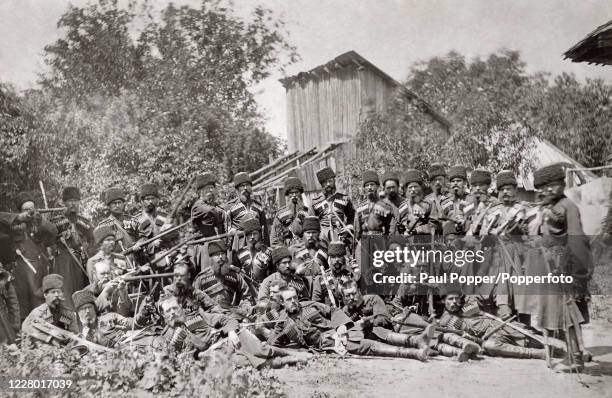 Kuban Cossacks pose in their uniforms and with their weapons and ammunition, circa 1930.
