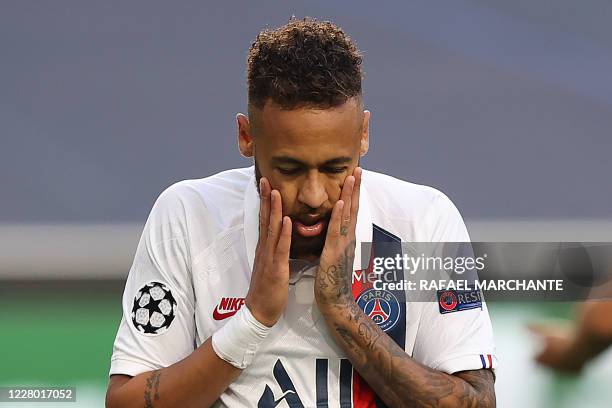 Paris Saint-Germain's Brazilian forward Neymar reacts after missing to score a goal during the UEFA Champions League quarter-final football match...