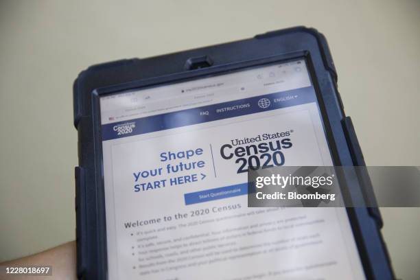 Youth ambassador holds a tablet with a Census 2020 interview questionnaire during a community food distribution at a YMCA location in Los Angeles,...