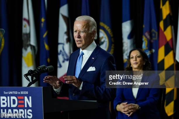 Presumptive Democratic presidential nominee former Vice President Joe Biden speaks as his running mate Sen. Kamala Harris looks on during an event at...