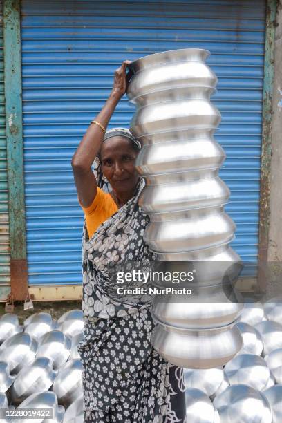 Woman labor works in an aluminium factory amid the coronavirus pandemic in Dhaka, Bangladesh, on August 12, 2020