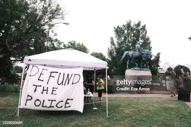 Banner that reads "Defund The Police" is seen during the "Reclaim the Park" gathering at Emancipation Park on August 12, 2020 in Charlottesville,...