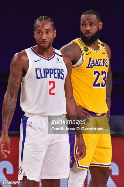Orlando, FL Kawhi Leonard of the LA Clippers and LeBron James of the Los Angeles Lakers look on during the game on July 30, 2020 at The Arena at ESPN...