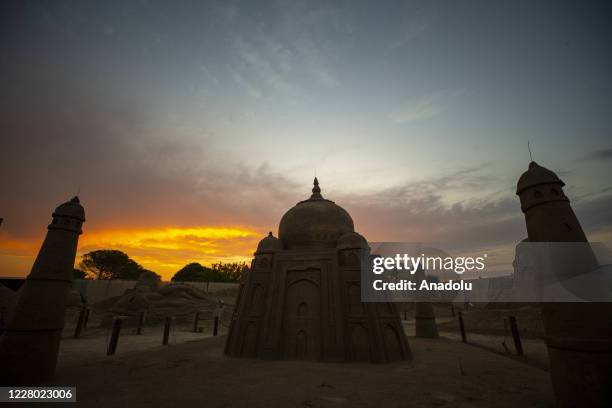 Sand sculpture of Taj Mahal is displayed at the 15th International Sand Sculpture Festival, organised under the "Sea Legends" theme during sunset in...