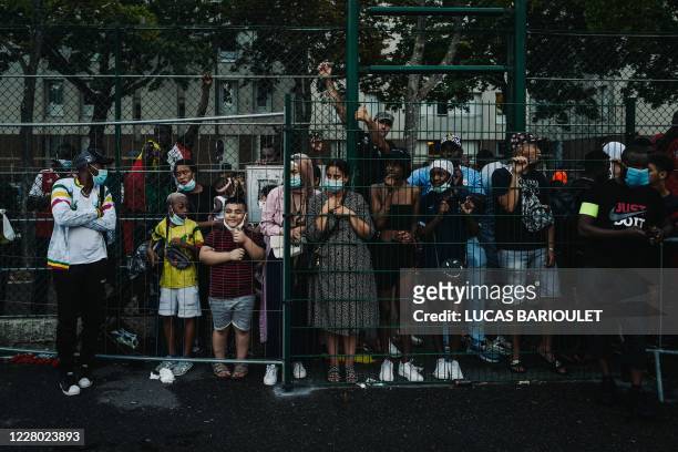 In this photograph taken on August 12 supporters look on as a "Mali" team and a "Rest of the World" team compete during the "CAN des quartiers" final...