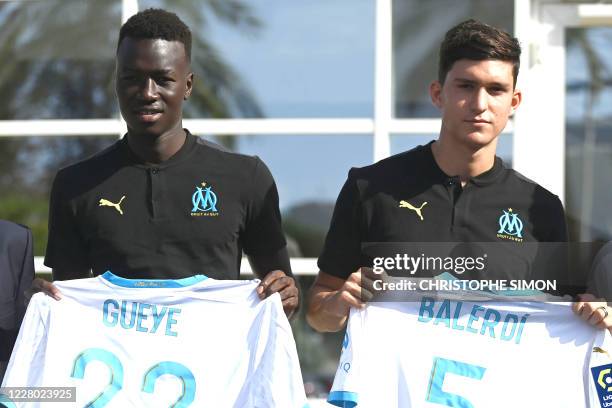 New Olympique de Marseille's players French midfielder Pape Gueye and Argentinian defender Leonardo Balerdi pose with their shirts in Marseille,...