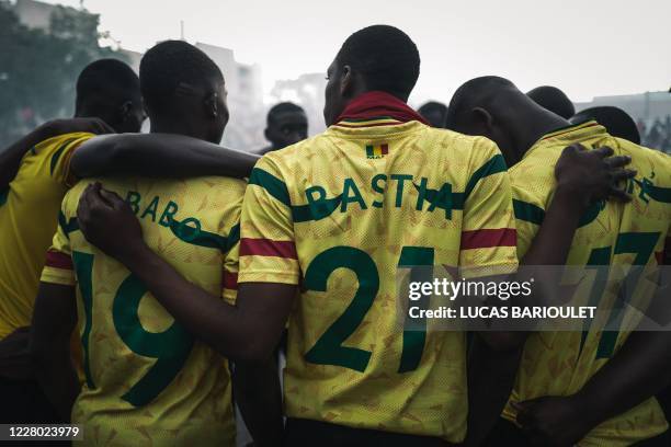 In this photograph taken on August 12 Malian players gather as they prepare to play a "Rest of the World" team in the "CAN des quartiers" final...