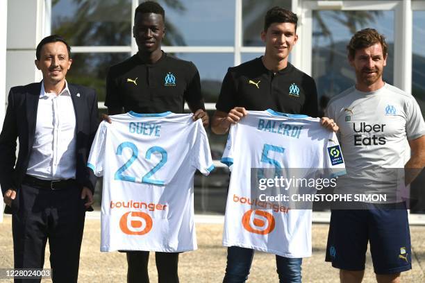 New Olympique de Marseille's players French midfielder Pape Gueye and Argentinian defender Leonardo Balerdi pose next to new director Spaniard Pablo...