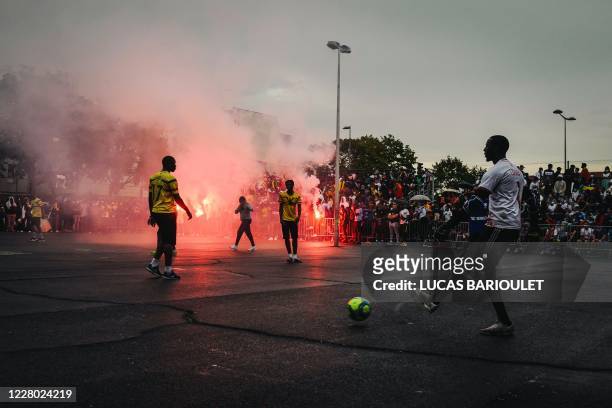 In this photograph taken on August 12 footballers representing a "Mali" team and a "Rest of the World" team compete during the "CAN des quartiers"...