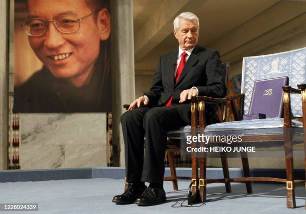 Chairman of the Nobel Committee Thorbjoern Jagland looks down at the reserved vacant chair of Nobel Laureate Liu Xiaobo , on which Jagland placed the...