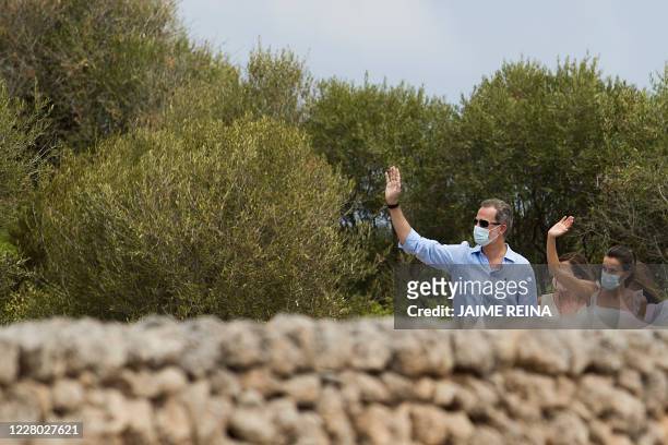Spanish King Felipe VI and his wife Queen Letizia visit the Naveta of Es Tudons site in Ciutadella on the Balearic island of Menorca on August 13,...