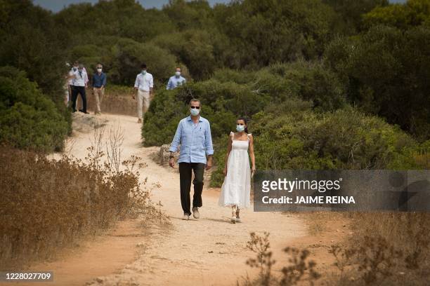 Spanish King Felipe VI and his wife Queen Letizia visit the Naveta of Es Tudons site in Ciutadella on the Balearic island of Menorca on August 13,...