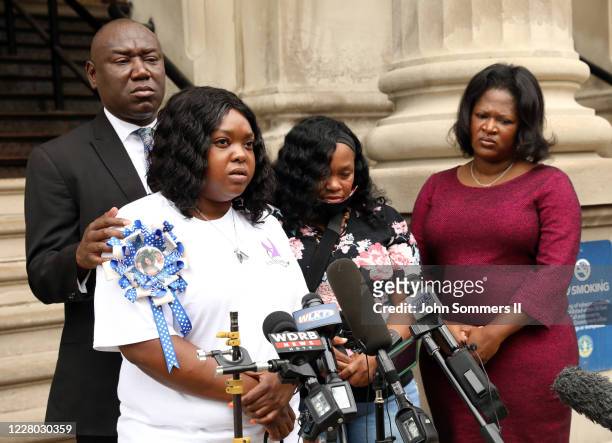 Breonna Taylor's aunt Bianca Austin, front, addresses the media during a press conference over the speed of the investigation of her niece's death as...
