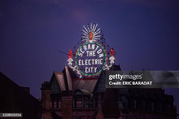 "Scranton, The Electric City" neon lights is seen as the sun sets over the Court House in the Downtown area of Scranton, Pennsylvania, on August 11,...