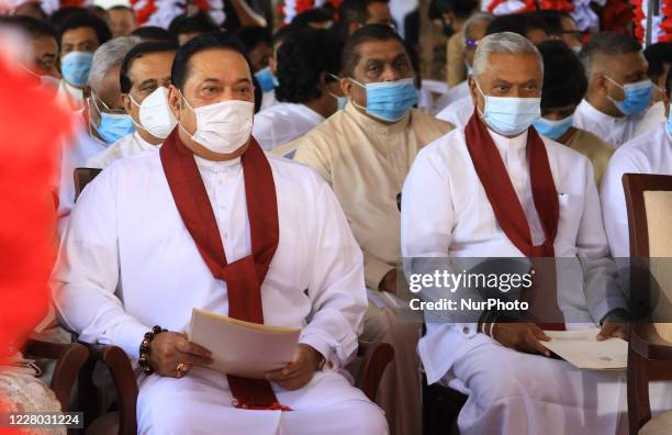 Sri Lankan prime minister Mahinda Rajapaksa and his elder brother Chamal Rajapaksa wearing face masks wait for the arrival of their brother Gotabaya...