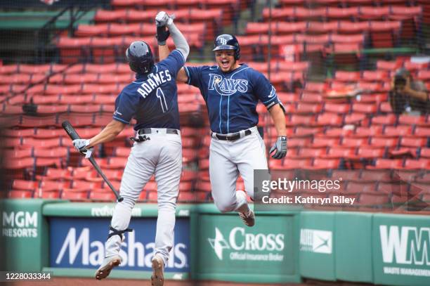 Hunter Renfroe celebrates with teammate Willy Adames of the Tampa Bay Rays after hitting a two run home run in the third inning against the Boston...