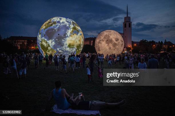 Giant inflatable model of the Moon, and the planet Earth, exhibited by the Brno Observatory and Planetarium are seen on the Cow's Hill in Brno, Czech...