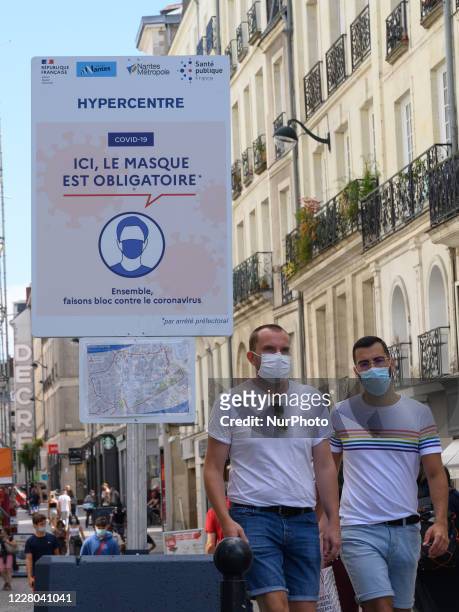 People walk downtown Nantes, France on August 14, 2020. Faced with the multiplication of cases of Coronavirus / Covid-19, the city of Nantes has...