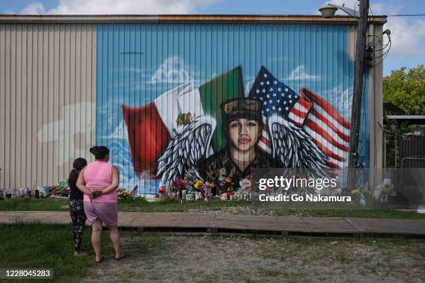 People pay their respects at a mural for murdered U.S. Army Private First Class Vanessa Guillen near Cesar Chavez High School, where a memorial...