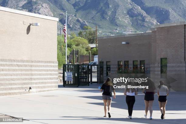 Students walk off the campus after collecting their books for the upcoming school year at Catalina Foothills High School in Tucson, Arizona, U.S., on...