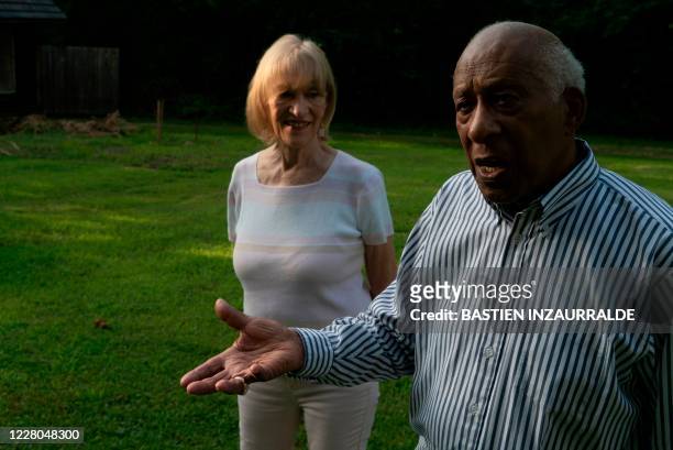 Daniel Smith and his wife Loretta Neumann walk in the backyard of their home in Northwest Washington during an interview with AFP on August 5 in...