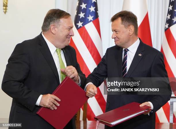 Secretary of State Mike Pompeo and Poland's Minister of Defence Mariusz Blaszczak greet each other with an elbow bump after signing the US-Poland...