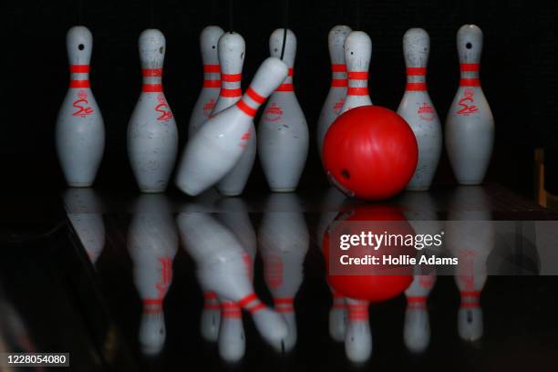 Pins are bowled over at All Star Lanes bowling alley at Westfield in White City on August 15, 2020 in London, England. Theatres, casinos and bowling...