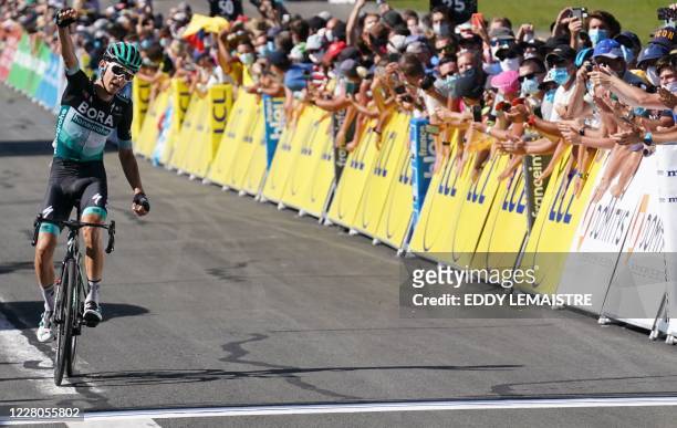 Team Bora rider Germany's Lennard Kamna celebrates as he crosses the finish line at the end of the fourth stage of the 72nd edition of the Criterium...