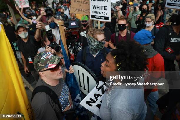 Woman argues with a far right protester during a rally on August 15, 2020 near the downtown of Stone Mountain, Georgia.