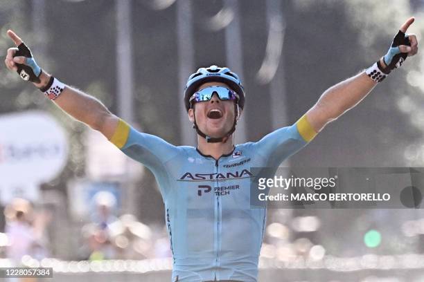 Astana Pro Team Denmark rider Jakob Fuglsang celebrates as he crosses the finish line at the end of the 114th edition of the giro di Lombardia , a...