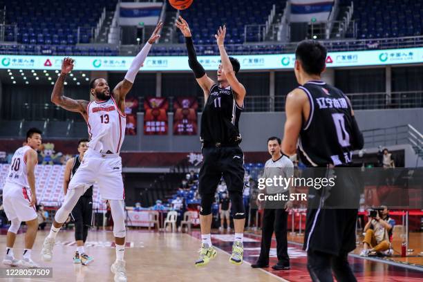 Sonny Weems of Guangdong Southern Tigers competes the ball with Liu Zhixuan of Liaoning Flying Leopards during their Chinese Basketball Association...