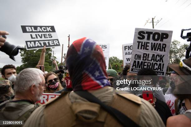 Anti-racist and anti-facist protesters orgranized by F.L.O.W.E.R, a frontline organization based in Atlanta to combat racism face off against far...