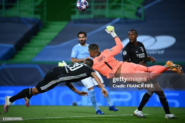 Lyon's Portuguese goalkeeper Anthony Lopes vies for the ball beside Lyon's Brazilian defender Marcal during the UEFA Champions League quarter-final...