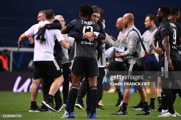 Lyon's Brazilian midfielder Thiago Mendes celebrates his team's win with sporting Director Juninho Pernambucano at the end of the UEFA Champions...