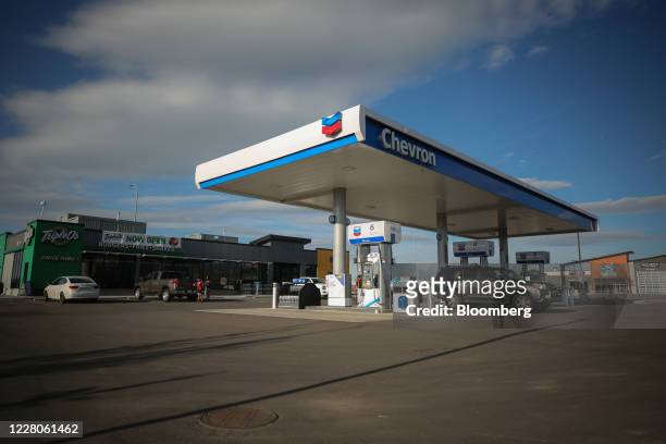 Vehicles sit parked at a Chevron Corp. Gas station in Calgary, Alberta, Canada, on Friday, Aug. 14, 2020. Despite a 24% drop in fuel and petroleum...