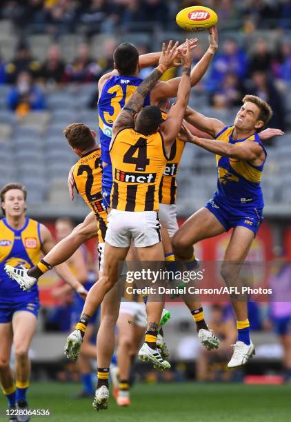 Josh Rotham and Brad Sheppard of the Eagles compete for a mark with Jarman Impey of the Hawks during the 2020 AFL Round 12 match between the West...