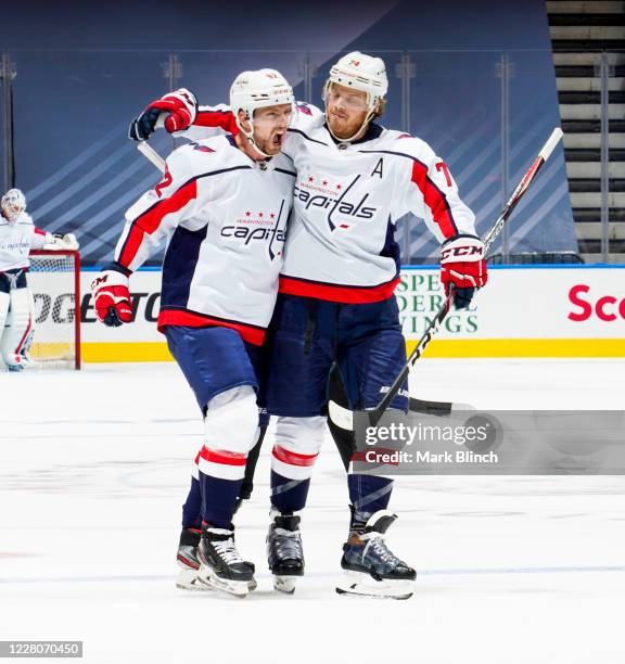 Evgeny Kuznetsov of the Washington Capitals celebrates his goal against the New York Islanders with teammate John Carlson during the second period in...