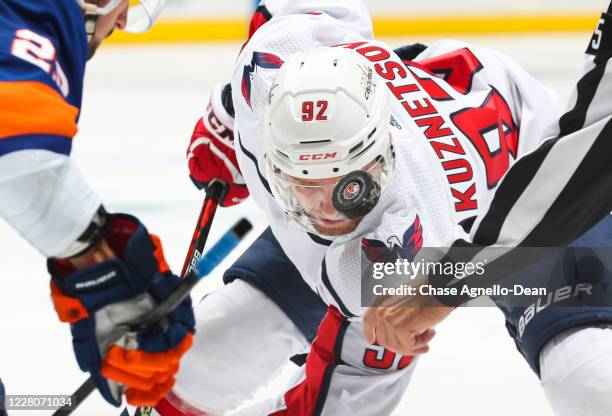 Evgeny Kuznetsov of the Washington Capitals takes a face-off against Brock Nelson of the New York Islanders during the third period in Game Three of...