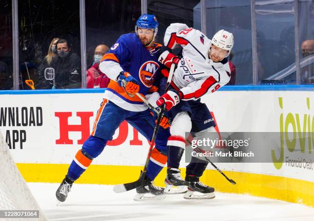 Adam Pelech of the New York Islanders battles against Evgeny Kuznetsov of the Washington Capitals during the second period in Game Three of the...