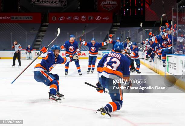 Mathew Barzal of the New York Islanders celebrates his game winning goal against the Washington Capitals during overtime in Game Three of the Eastern...