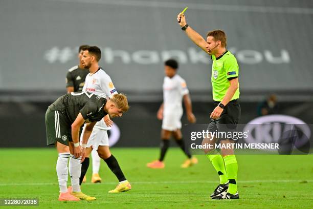 Manchester United's English defender Brandon Williams is is shown a yellow card by German referee Felix Brych during the UEFA Europa League...
