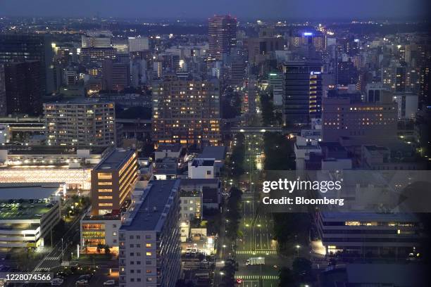 Commercial and residential buildings stand at night in Chiba, Japan, on Saturday, Aug. 15, 2020. Japans economy shrank last quarter by the most in...