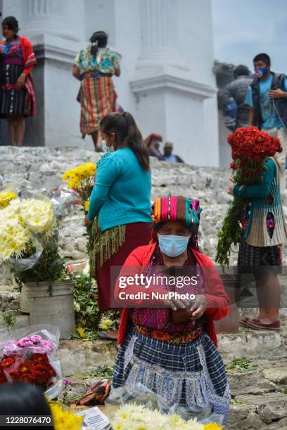 Woman sells flowers at the Chichicastenango market 150 kilometers west of Guatemala City, Guatemala, on August 16, 2020. President Alejandro...