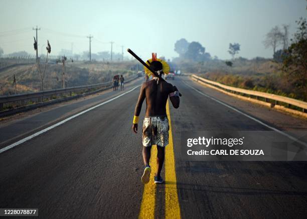 Member of the Kayapo tribe walks along the middle of the BR163 highway during a protest outside Novo Progresso in Para state, Brazil on August 17,...