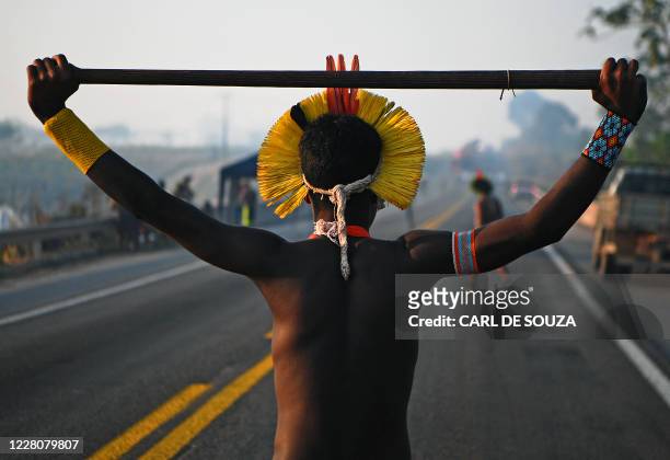 Member of the Kayapo tribe walks along the middle of blocked highway BR163 during a protest on the outskirts of Novo Progresso in Para State, Brazil,...