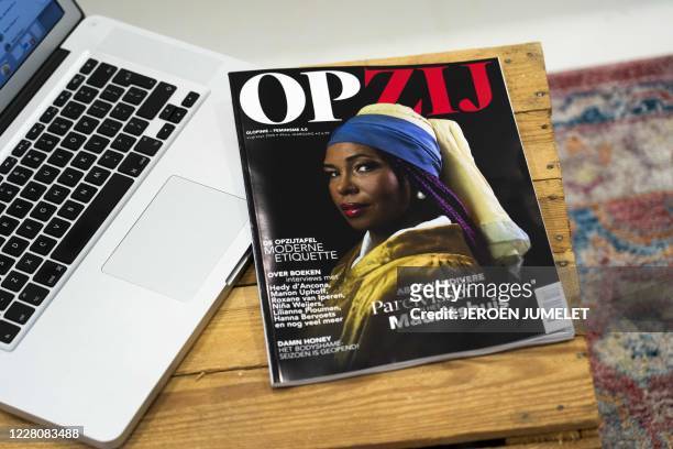 The cover of THE Dutch magazine OPZIJ with a cover showing the black Abbie Vandivere, curator of the Mauritshuis, depicted as the white girl with a...