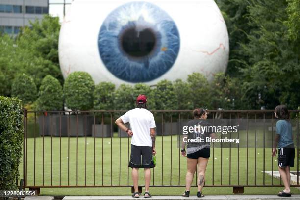 People stop to look at an art installation in downtown Dallas, Texas, U.S., on Monday, Aug. 17, 2020. Texas officials have launched an investigation...
