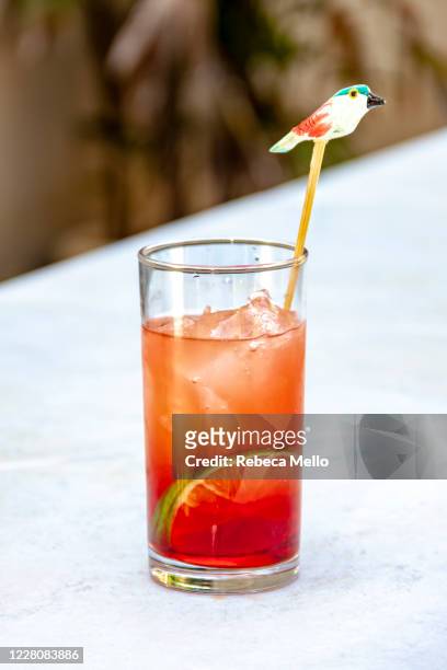 red cocktail in long glass - craft cocktail stock pictures, royalty-free photos & images