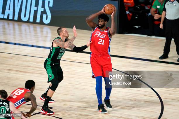 Joel Embiid of the Philadelphia 76ers looks for a pass against Daniel Theis of the Boston Celtics during the first half at The Field House at ESPN...